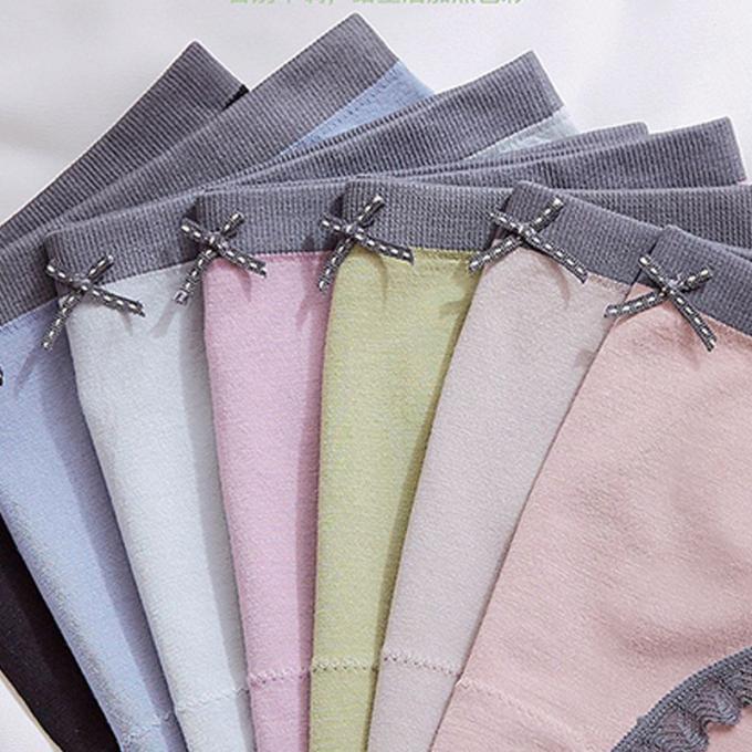 A cuecas por atacado do roupa interior ata o calcinha do biquini para mulheres meados de sem emenda do roupa interior do algodão da cintura das mulheres