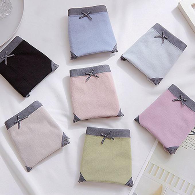 A cuecas por atacado do roupa interior ata o calcinha do biquini para mulheres meados de sem emenda do roupa interior do algodão da cintura das mulheres